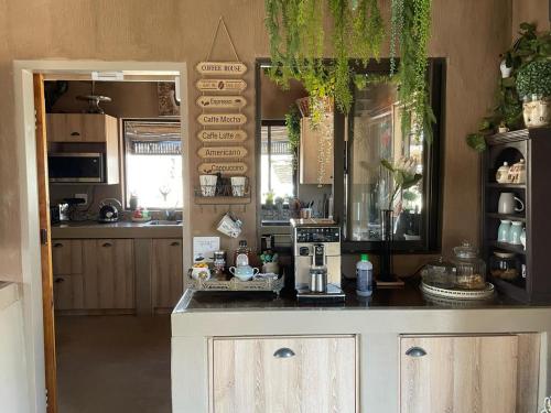 a kitchen with a counter with a coffee maker on it at Kulilo Lodge in Thabazimbi