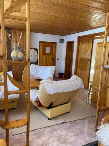 a bedroom with two bunk beds and a table at Family Hotel Markony in Pamporovo