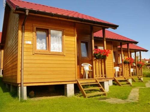 a small wooden house with a red roof at Pelikan in Sianozety