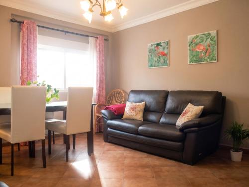 a living room with a couch and a table at Comfortable Apartment Ayamonte Garden in Ayamonte