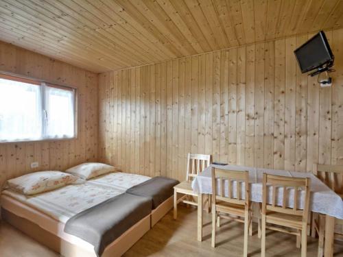 a bedroom with a bed and a table and chairs at Pelikan in Sianozety