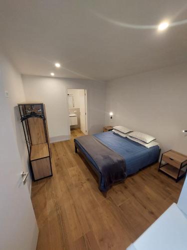 a bedroom with a bed and a wooden floor at Appartamento ZUFALL in Cogolo