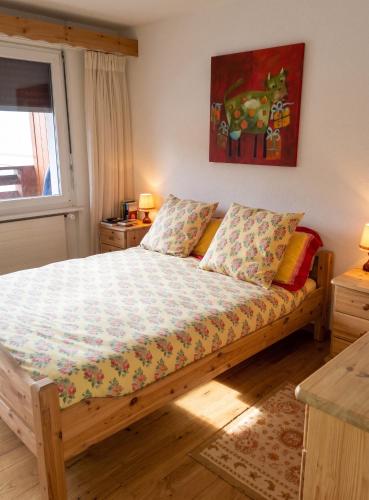 a bedroom with a wooden bed with at Spacious Apartment in Lens with Mountain View in Lens