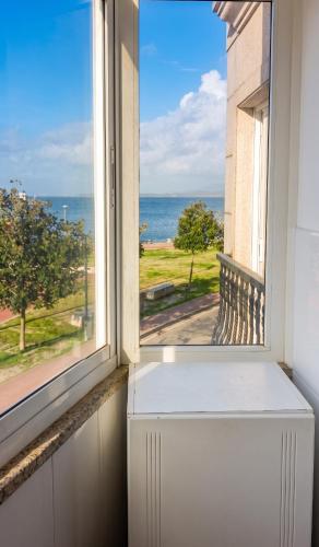 an open window with a view of the ocean at Charming Apartment in El Grove, Sea View in O Grove