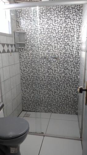 a bathroom with a shower with a toilet in it at Pousada Araguaia in Agrestina