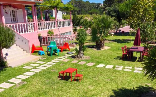 a group of colorful chairs and tables in a yard at Charming Apartment in Sintra with Pool in Sintra