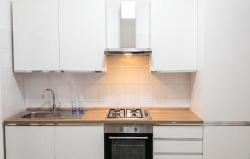 a kitchen with white cabinets and a sink at Spacious Apartment in Pescara, 120 m², Ideal for Families in Pescara