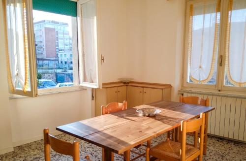 a dining room with a wooden table and chairs at Spacious Apartment in Pescara, 120 m², Ideal for Families in Pescara
