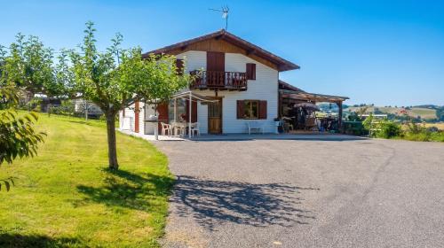 a house with a tree in front of it at Charmante maison avec piscine privée à Orsanco - 70 m² in Orsanco