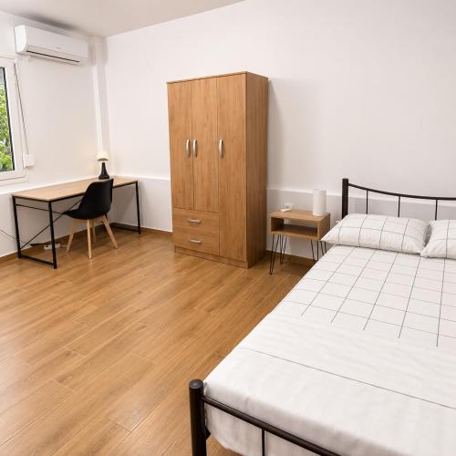 a bedroom with two beds and a desk and a cabinet at studio room with private bathroom-floor 2 in Athens