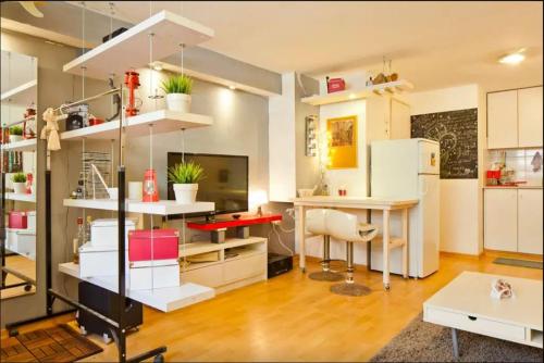een woonkamer met een bureau en een tafel bij Boardwalk Sea Apartment in Tel Aviv
