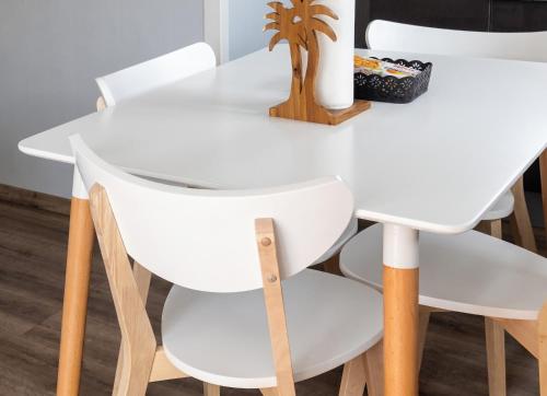 a white dining table and chairs in a room at Studio confortable à Sainte-Suzanne, 20 m², balcon in Sainte-Suzanne