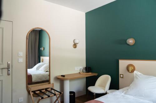a bedroom with a mirror and a bed and a desk at Domaine de Beaucens in Beaucens