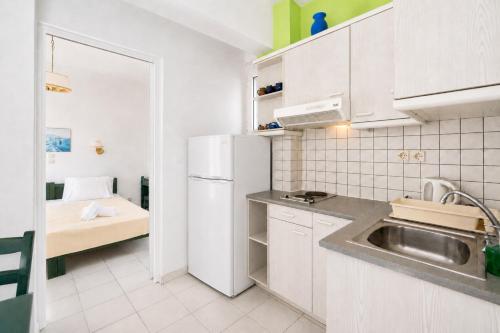 a kitchen with a sink and a white refrigerator at Villa Zefiros in Kipri