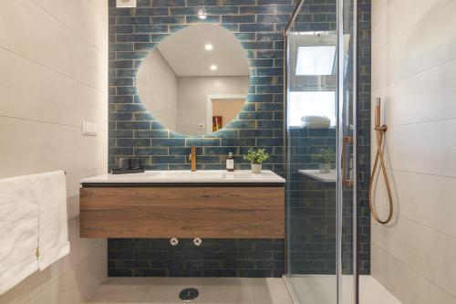 a bathroom with a sink and a mirror at Bia in Almancil