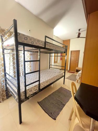 a bedroom with two bunk beds in a room at Neha's Homestay in Mysore