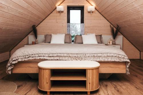 a bedroom with a large bed in a attic at Domki & Jacuzzi w Centrum Soliny 885-053-839 in Solina
