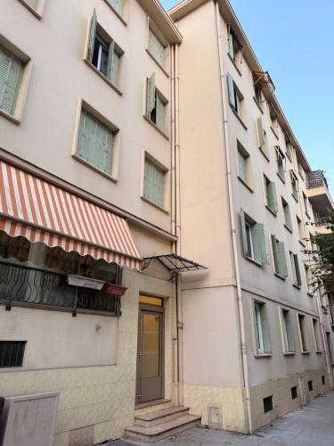 a building with a yellow door in front of it at Twin room in Nice