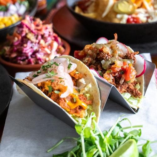 a couple of tacos sitting on a table with salad at Northover Manor Hotel in Ilchester