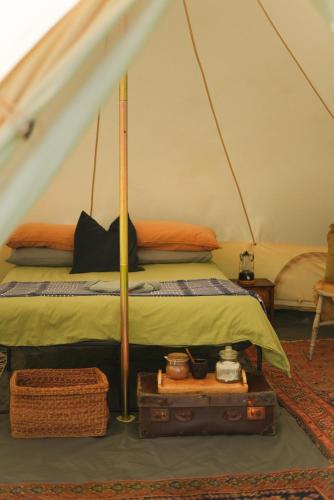 a bedroom with a bed in a tent at Devon Belltents - Beesands in Kingsbridge