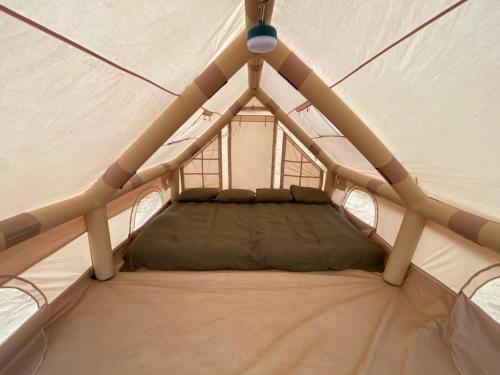 a small bed in a canvas tent at Secret Point Luxury Glamping in Panama