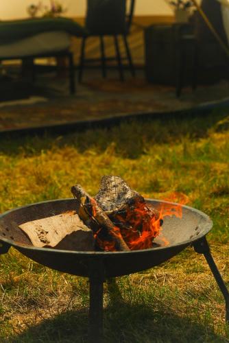a grill with some food on it in the grass at Devon Belltents - South Milton in Hope Cove
