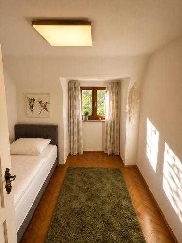 a bedroom with a bed and a window at Skoff Original Holzhaus in Eckberg