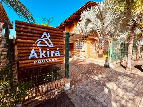 a sign for a akita pueblo in front of a fence at Akirá Pousada in Aquiraz