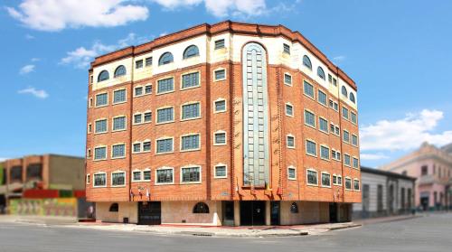 a red brick building with an arch on the side of it at Hotel Fontibon in Bogotá