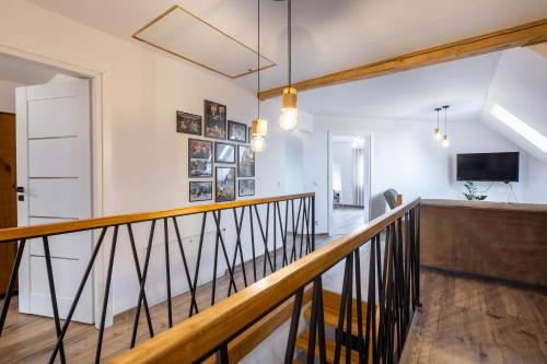 a hallway with a stair railing and a television at Cozy mountain house - Coolówka pod Babią Górą in Zubrzyca Dolna