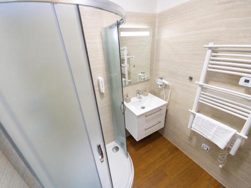 a bathroom with a sink and a mirror at Olympland Hotel in Trutnov