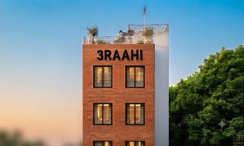 a brick building with a sign on top of it at 3 Raahi Varanasi in Varanasi