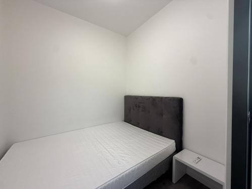 a small white room with a bed in it at La suite de Saint régis 1 in Le Puy-en-Velay