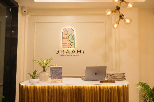 a table with a laptop on top of it at 3 Raahi Varanasi in Varanasi