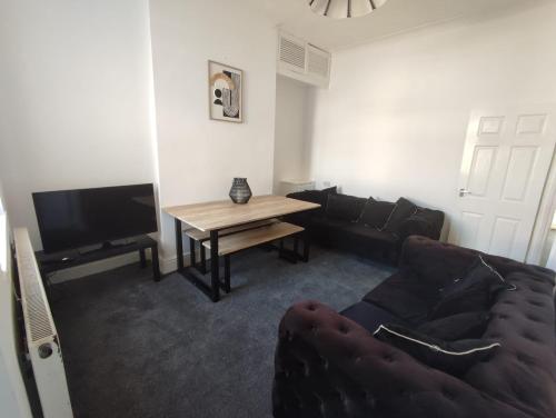 a living room with a couch and a table at Alexandra View in Goole