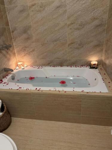a bathroom with a bath tub with flowers in it at Los Patos Waterfront Private Suites in Los Patos