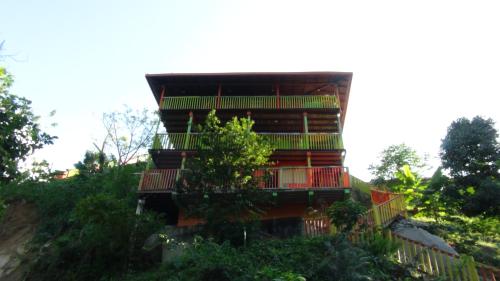 a building with balconies on the side of a hill at Cabañas Ecoturisticas Y Club Gaira Tayrona in Santa Marta