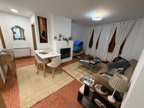 a living room with a couch and a table at La Sima del Anillo in Cardaño de Abajo
