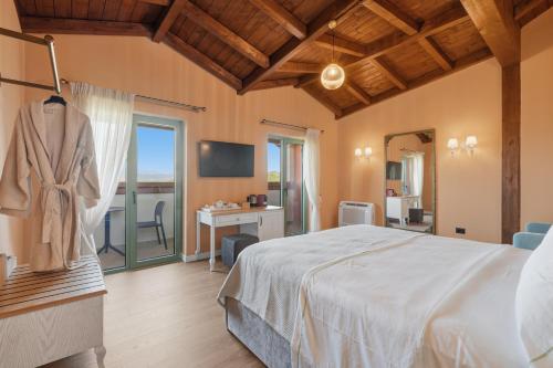 a bedroom with a bed and a desk and a television at Agroturizem Cialda in Shkallnur