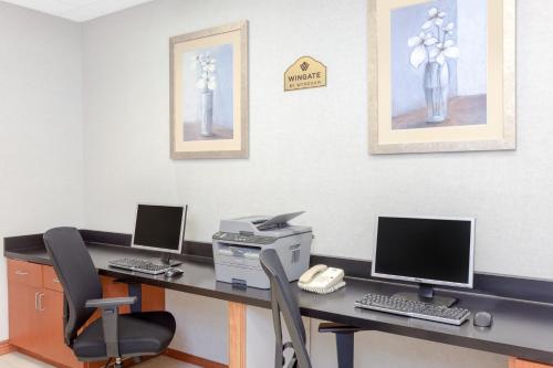 an office with a desk with two computers and a printer at Wingate by Wyndham Yuma in Yuma