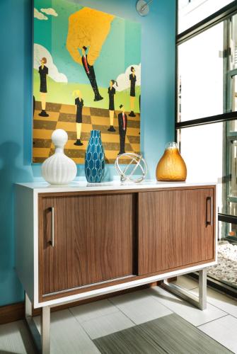 a cabinet with vases and a painting on the wall at Staypineapple, Hotel Z, Gaslamp San Diego in San Diego