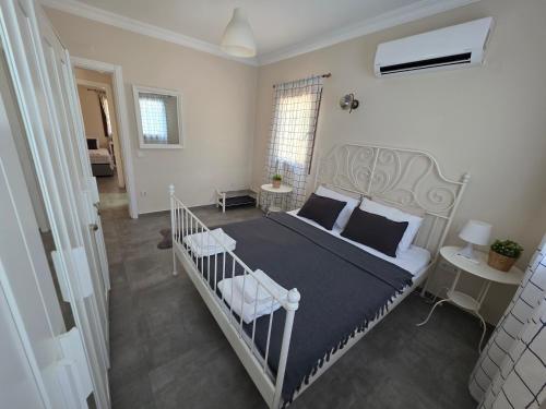 a bedroom with a bed with a black and white comforter at 2-Bedroom Flat with a Private Swimming Pool in Bodrum City