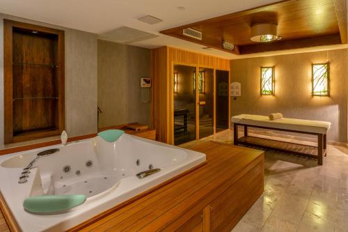 a large bathroom with a large tub in a room at Mavilu Luxury Hotel in Bodrum City