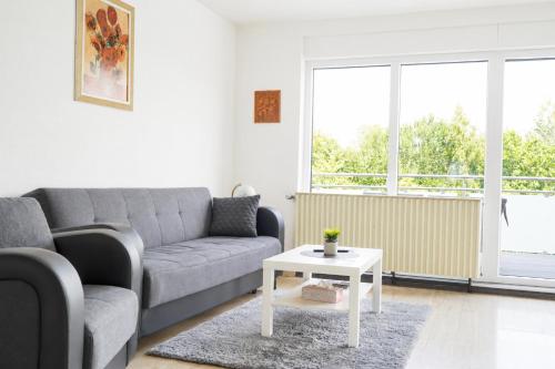 a living room with a couch and a table at Ferienwohnung Birke in Sankt Wendel