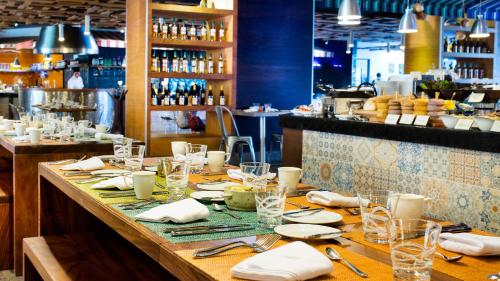 een lange tafel in een restaurant met borden en glazen bij Palacio Mundo Imperial Riviera Diamante Acapulco in Acapulco