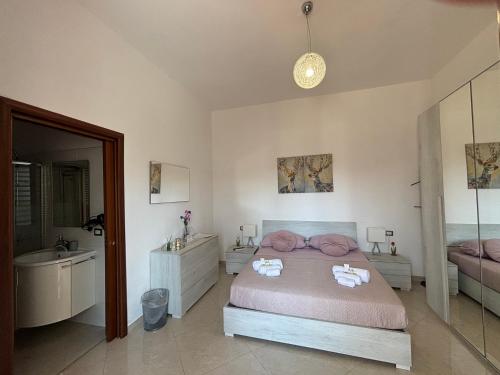 a bedroom with a bed and a sink and a mirror at B&B IL TULIPANO free private parking in Como