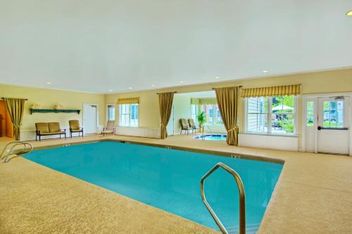 a large swimming pool in a large house at The Pointe at Castle Hill Resort & Spa in Ludlow