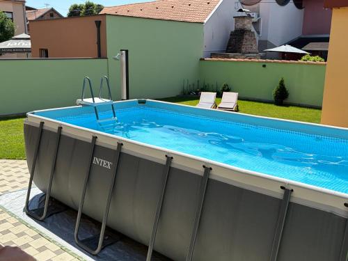 a hot tub in a backyard with a swimming pool at Apartman Cherry in Višnjevac