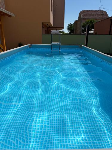 a swimming pool with blue tiles on top of a building at Apartman Cherry in Višnjevac