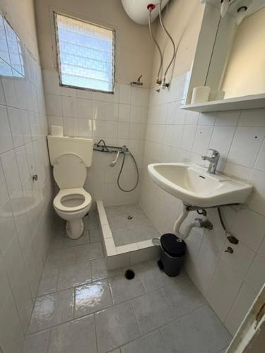 a bathroom with a toilet and a sink at Antilia corfu 4 in Agios Georgios